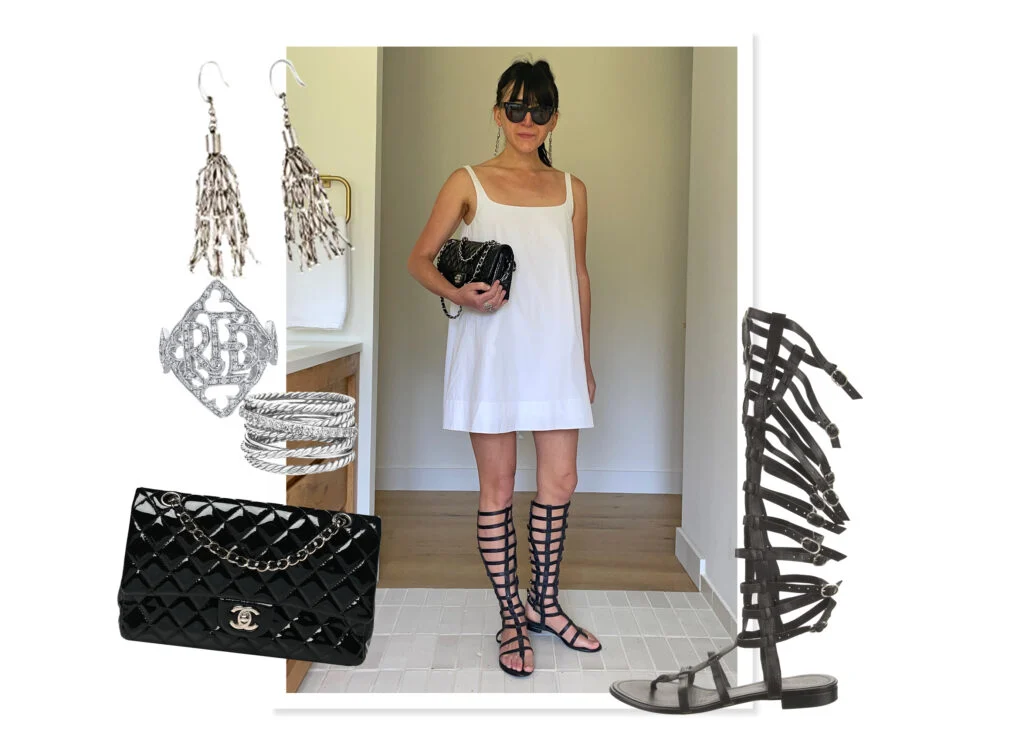 White dress shown with a black patent Chanel Classic Handbag, Chanel black gladiator sandals that go to the knee, and silver jewelry