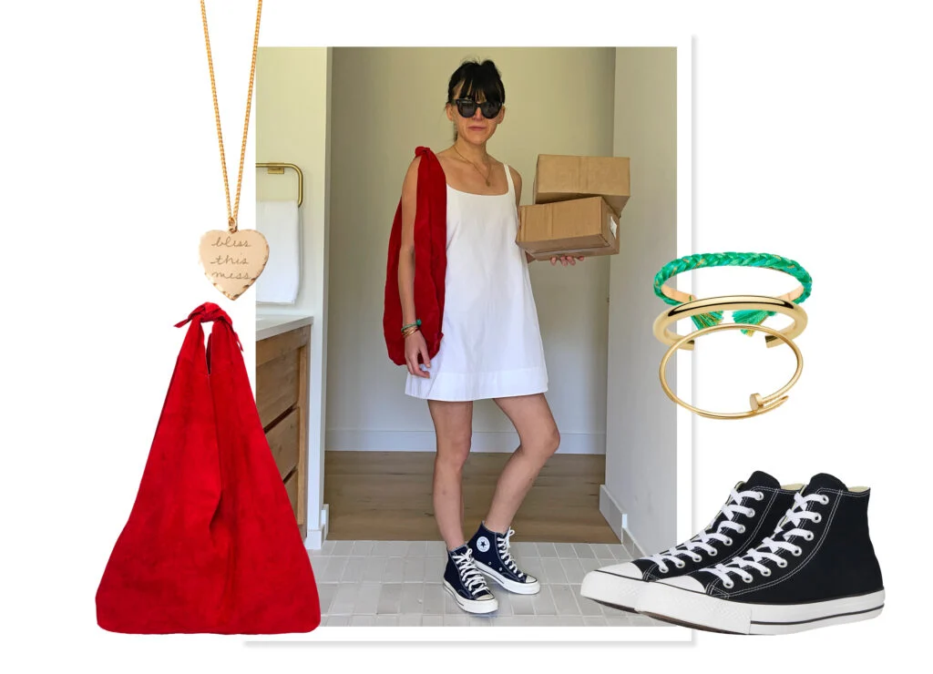 White dress shown with an oversized red suede bag, black Converse sneakers, and gold jewelry